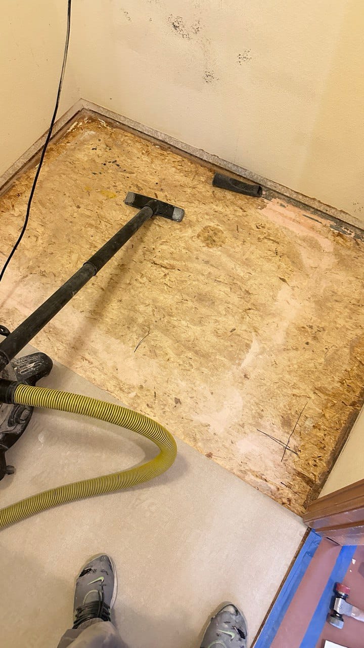 Subfloor preparation with a vacuum cleaner during a tile installation project